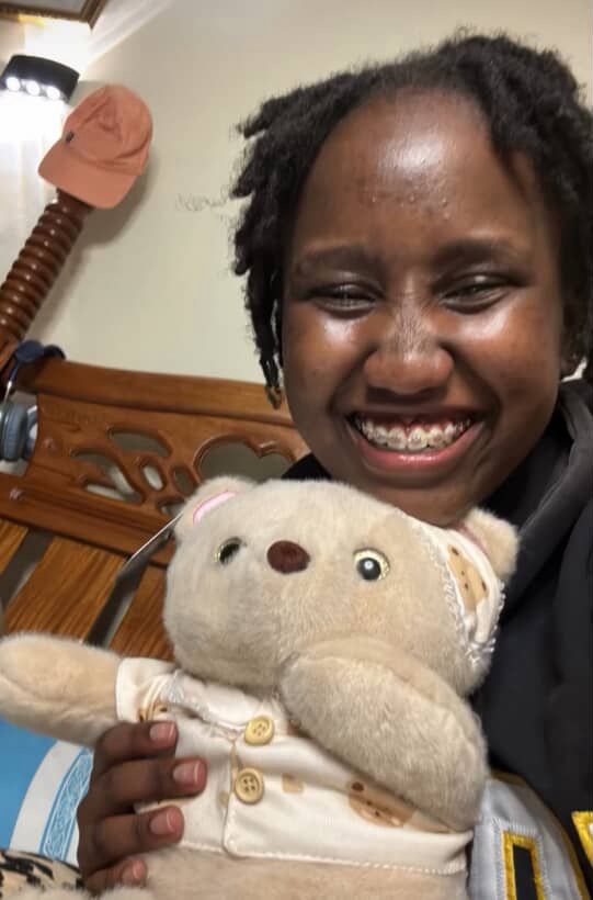 Girl Cuddling Lainika Bear